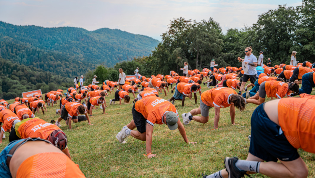 Hundreds of people doing mountain climber exercises on a mountain