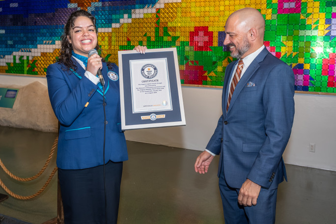 Adjudicator giving the record certificate to an event organizer