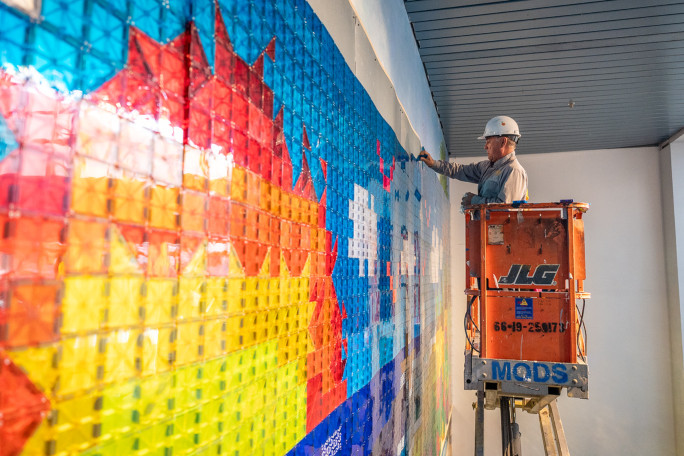 Side shot of a man assembling the mosaic