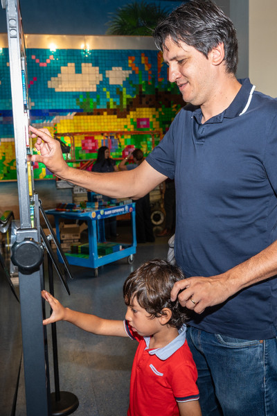 A son and father touching the magnatiles wall
