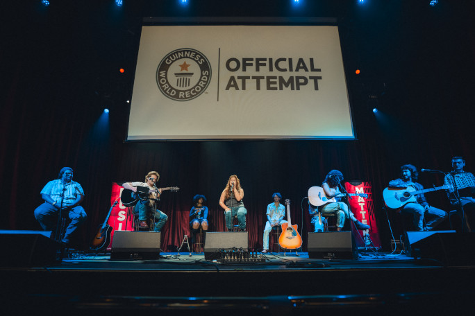 A group of songwriters performing onstage