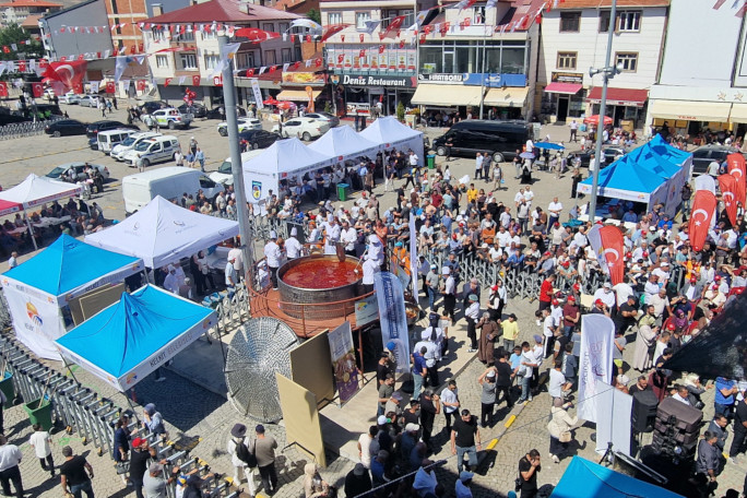 Drone shot from above of people stirring the beans