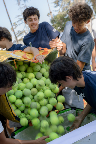 Closeup of the students dumping the balls into a container