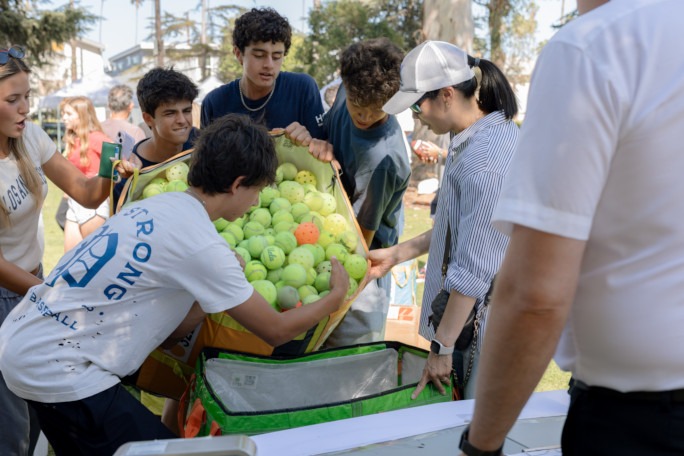 Students dumping the balls into another container