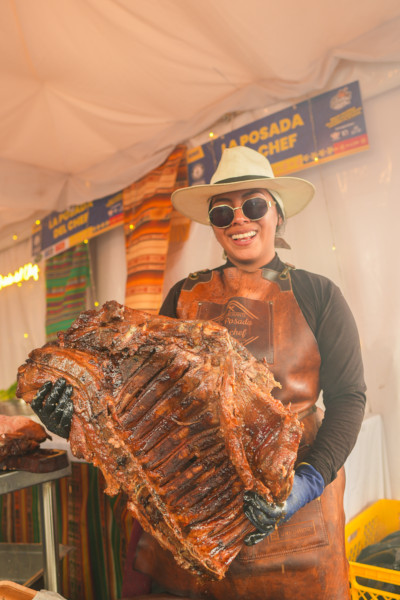 A woman holding up a rack of rib meat