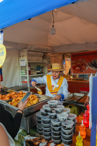 A woman dishing out fried food