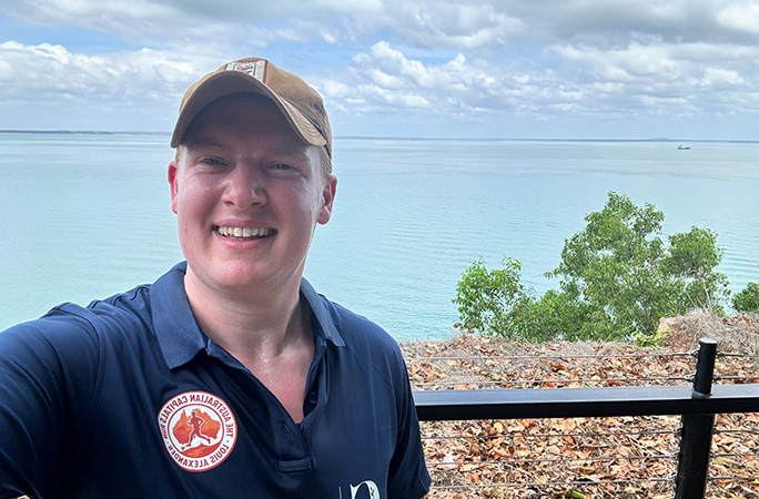 man wears a baseball cap and smiles