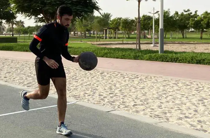 Man running while dribbling a basketball