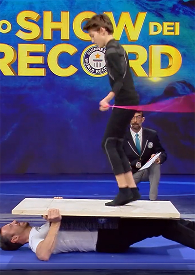 Cristian rope-skipping on a bed of nails