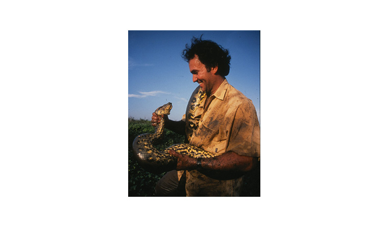 Dr Jesus Rivas holding an anaconda