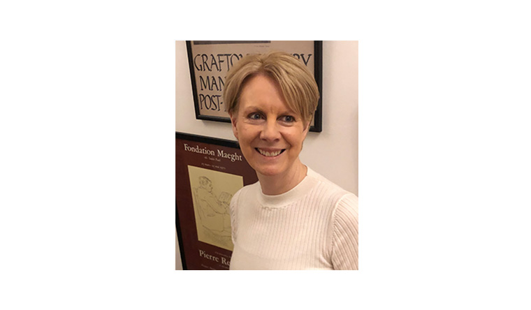 Kathryn Brown stood in front of some framed artwork