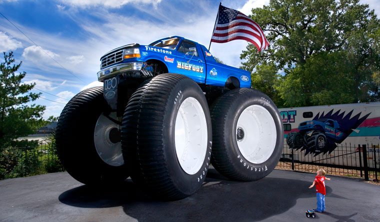 boy next to monster truck