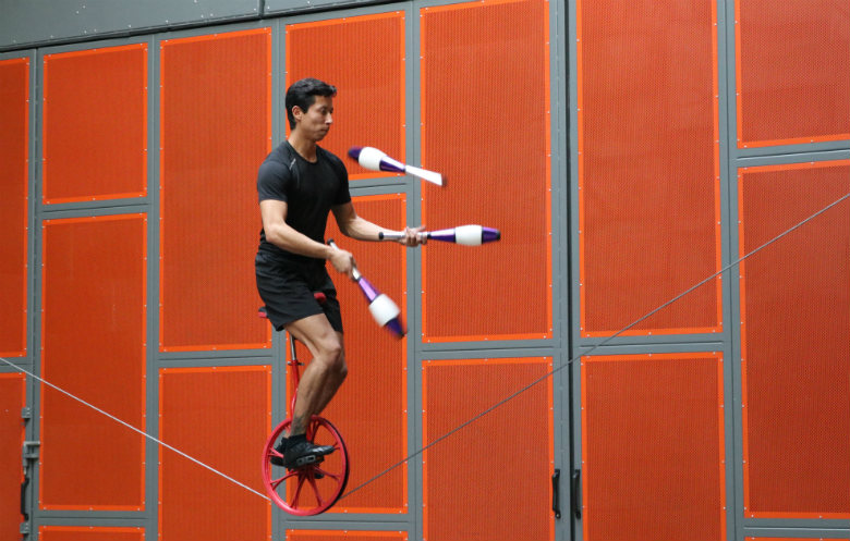 Most juggling catches on a unicycle whilst balancing on a slackwire in ...