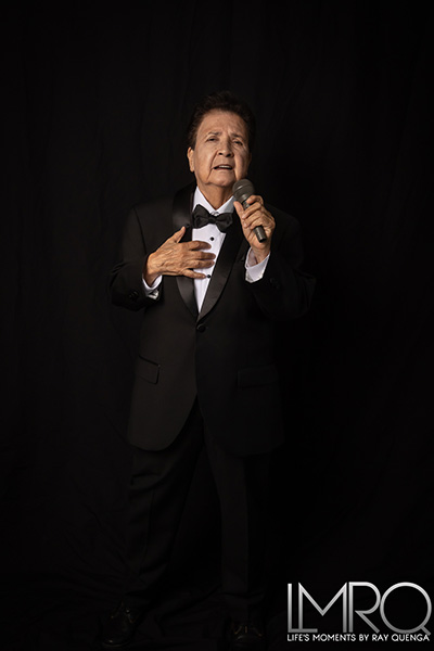 El Dana performing in a black and white suit
